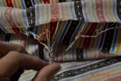 strings from unfinished fabric